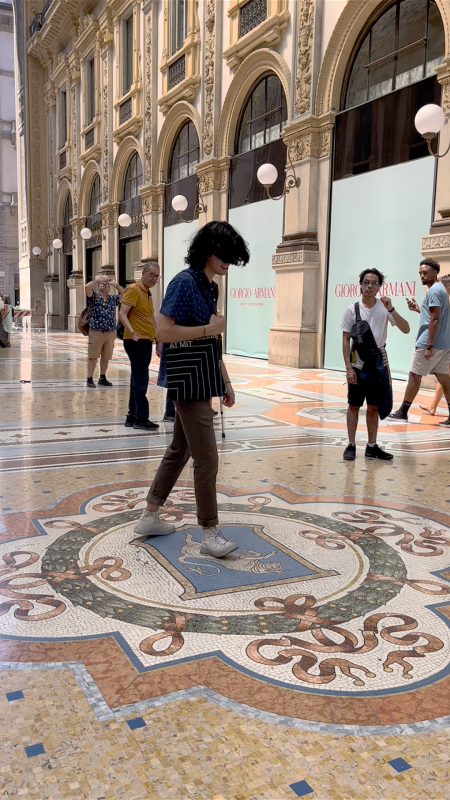 Diego Yanez-Laguna standing on a octogonal floor mosaic with a bull reared up on its hind legs in the Galleria Vittotio Emanuele Ii in Milan. 
