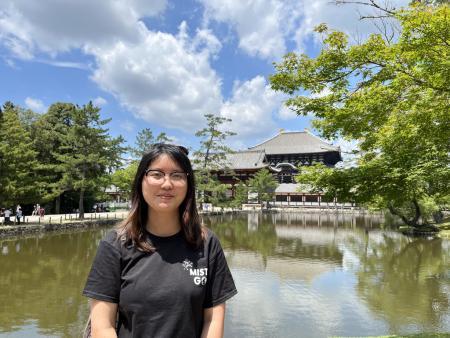 Headshot of Vicky Li with Tōdai-ji Temple and Kagamike Pond in the background