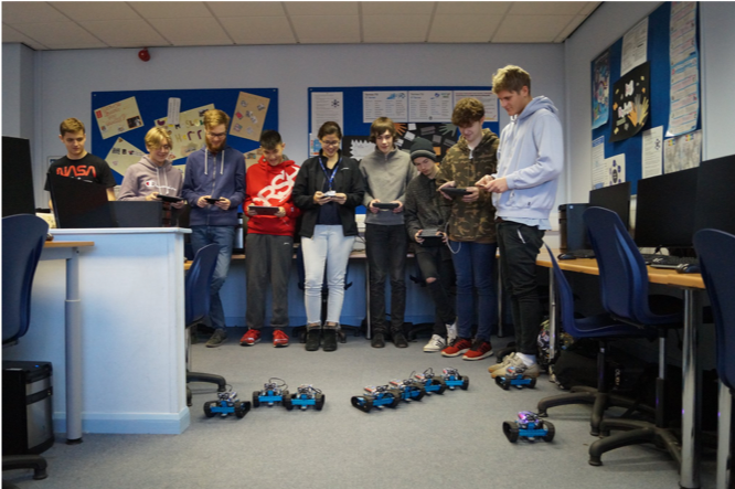 Students work with remote control robots