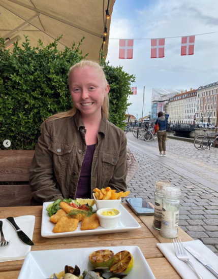 Abby at a restaurant in front of Danish flags