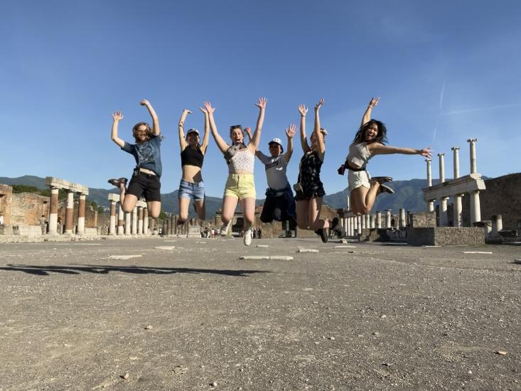 Emma Suh in a jumping shot along with 5 other MIT students in Pompeii