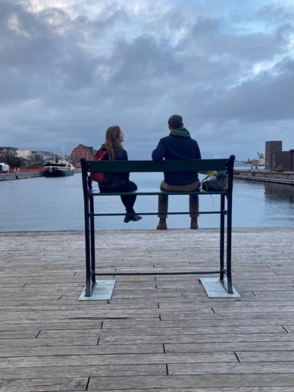 Ava and a friend on a tall bench on Copenhagen harborfront