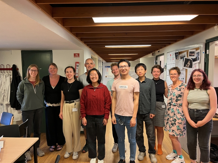 Allison Park with 10 colleagues in a hallway of University of Copenhagen