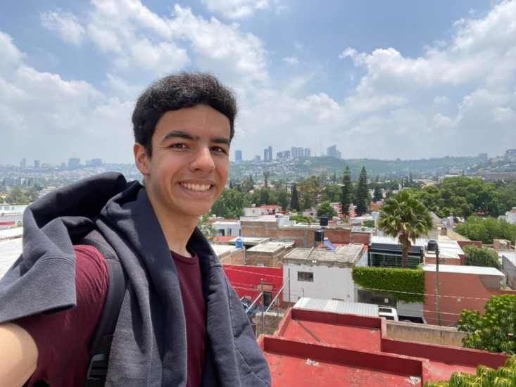 Selfie of Asael with Mexico skyline on a sunny and cloudy day