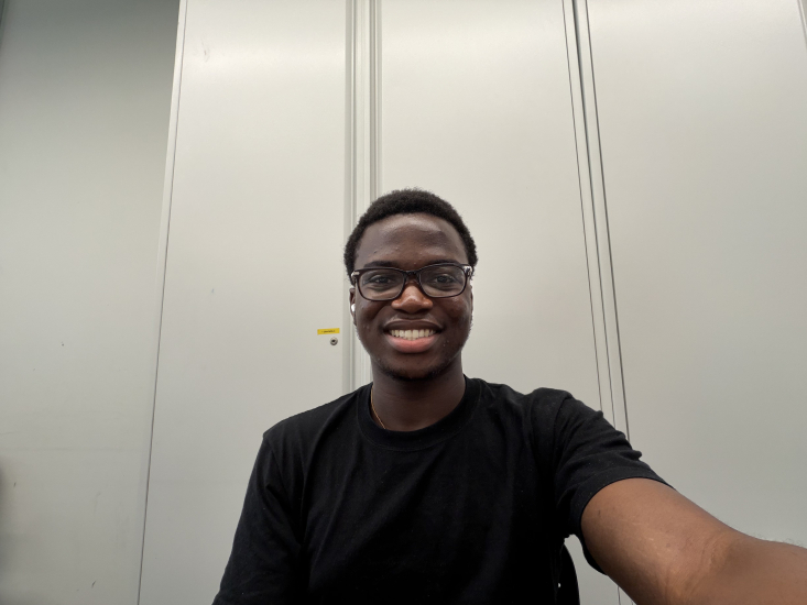 A selfie of David Sanwo in a white room