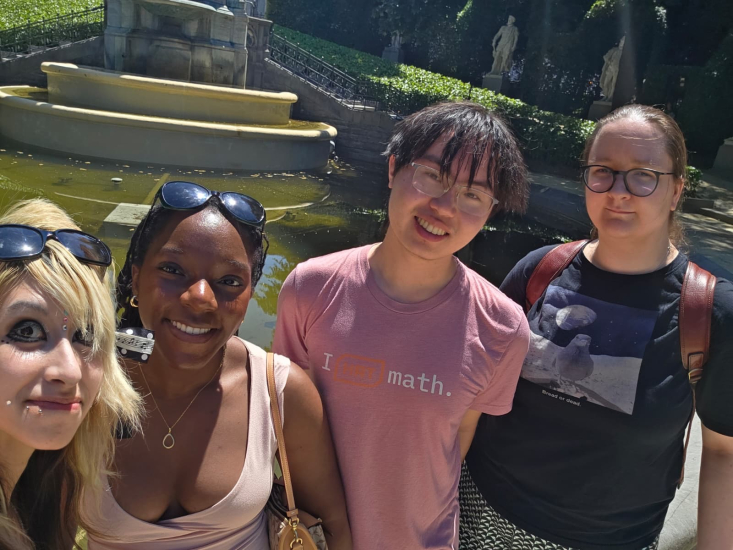 Janae F with three colleagues and a pond in the background