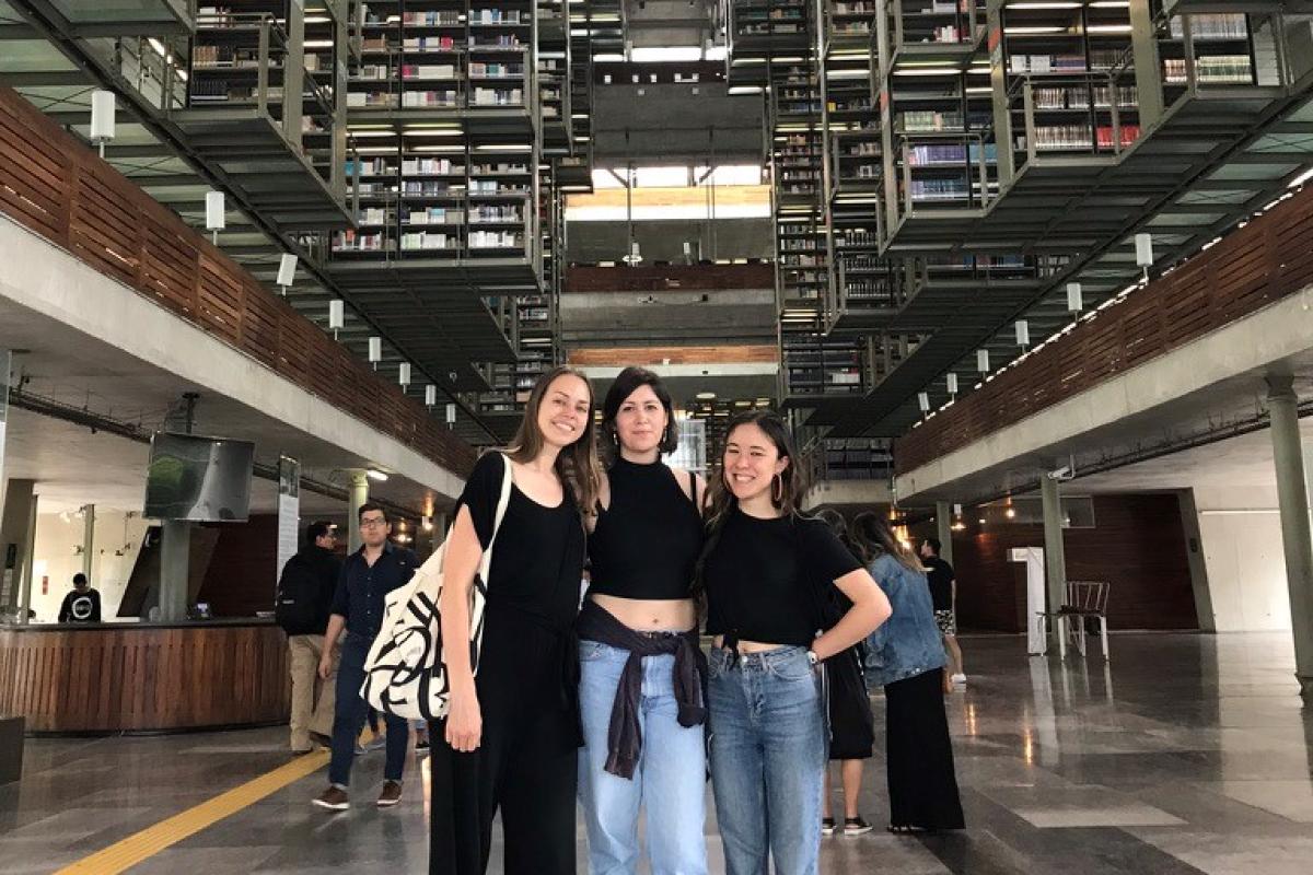 Anne with coworkers in a library 